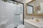 Guest bathroom has a walk-in shower with convenient seat.